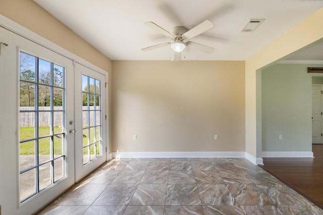 unfurnished room with french doors, plenty of natural light, baseboards, and visible vents