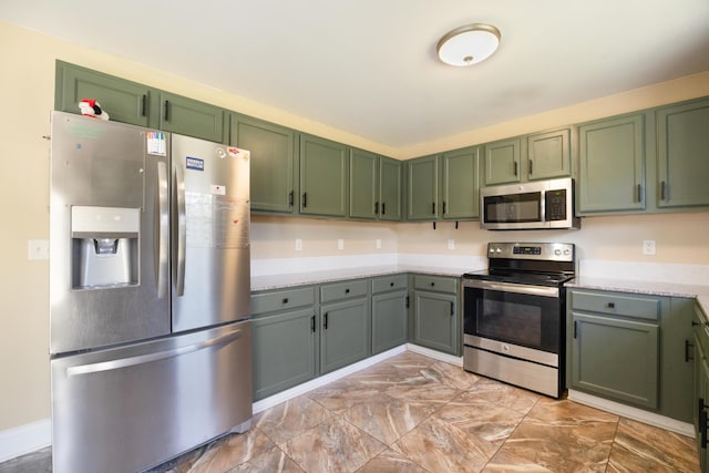 kitchen with stainless steel appliances and green cabinetry