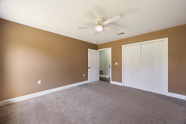 unfurnished bedroom featuring baseboards, visible vents, ceiling fan, and carpet