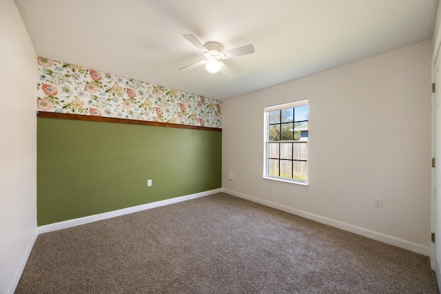 empty room featuring baseboards, carpet flooring, ceiling fan, and wallpapered walls