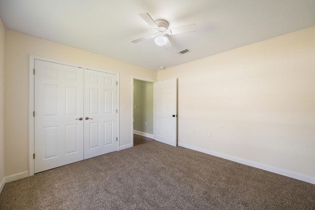 unfurnished bedroom with a closet, baseboards, visible vents, ceiling fan, and carpet