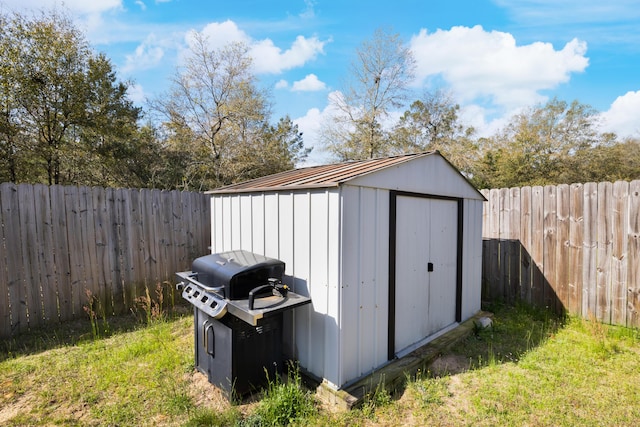 view of shed with a fenced backyard