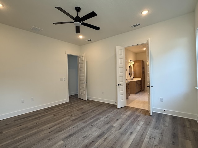 unfurnished bedroom featuring dark wood-type flooring, recessed lighting, visible vents, and baseboards