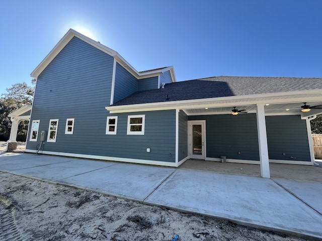 back of house featuring a patio, a shingled roof, and a ceiling fan