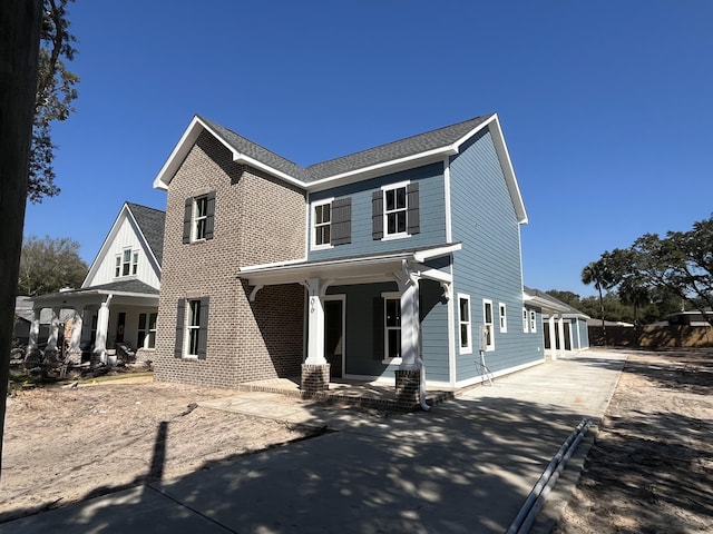 view of front of property with a porch and a shingled roof