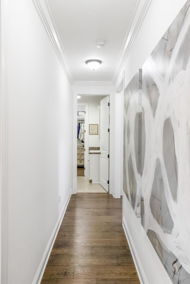 corridor with dark hardwood / wood-style flooring and crown molding