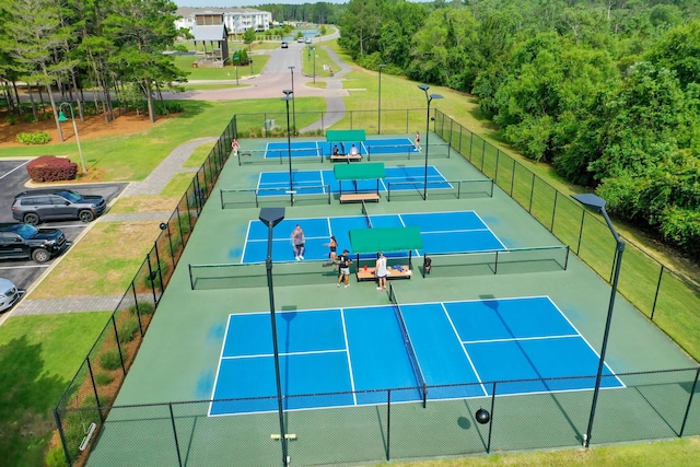 view of tennis court with a lawn