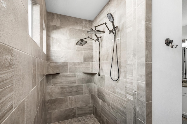 bathroom with a tile shower