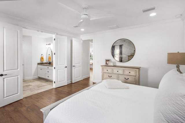 bedroom with ornamental molding, ensuite bath, ceiling fan, and dark wood-type flooring