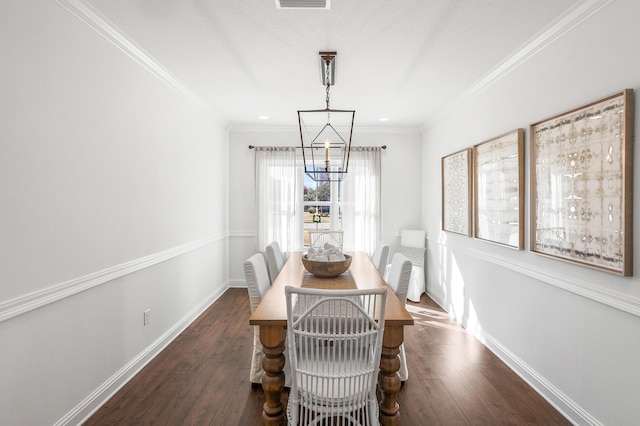 dining area featuring a chandelier, crown molding, and dark wood-type flooring