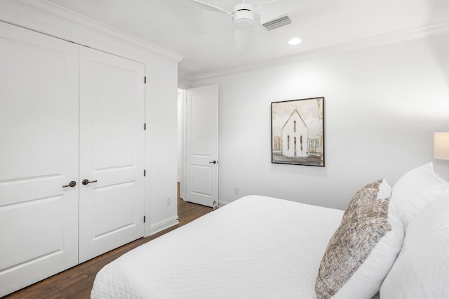 bedroom featuring a closet, ceiling fan, crown molding, and dark wood-type flooring