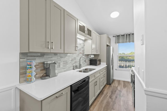 kitchen with decorative backsplash, light wood-type flooring, sink, black appliances, and gray cabinets