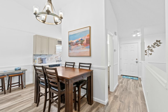 dining room featuring light hardwood / wood-style flooring and an inviting chandelier