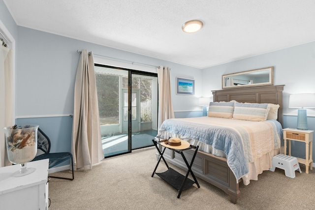 carpeted bedroom featuring access to outside and a textured ceiling