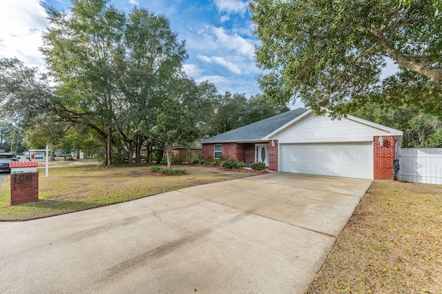 ranch-style house featuring a front yard and a garage