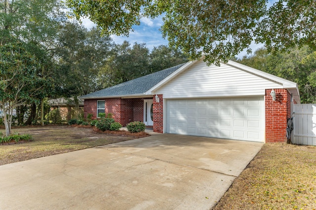 ranch-style home with a garage and a front lawn