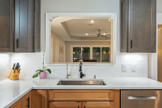 kitchen with sink, ceiling fan, stainless steel dishwasher, and decorative backsplash