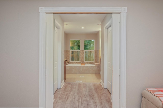 hallway with light hardwood / wood-style flooring