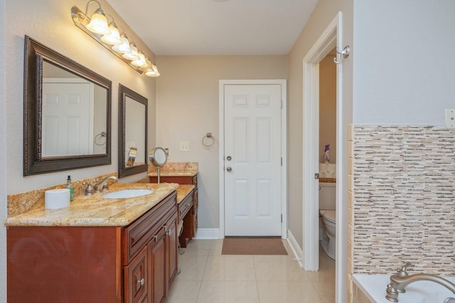 bathroom featuring toilet, a washtub, tile patterned floors, and vanity