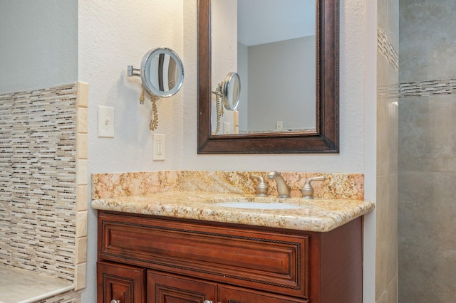 bathroom with a shower and vanity