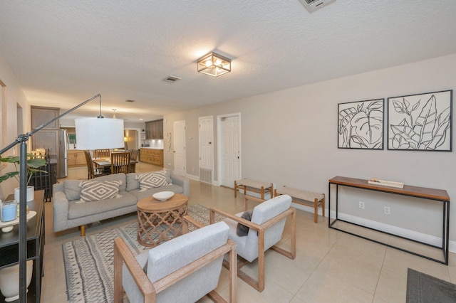 tiled living room with a textured ceiling