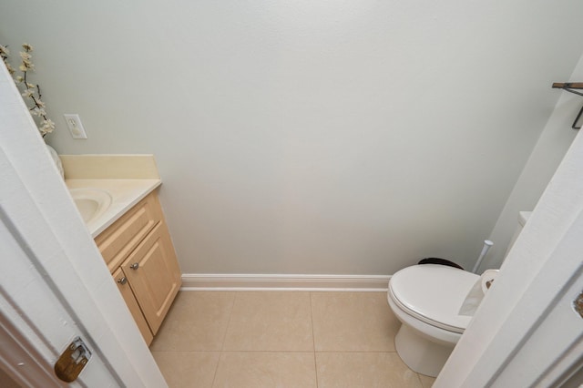 bathroom with toilet, tile patterned flooring, and vanity