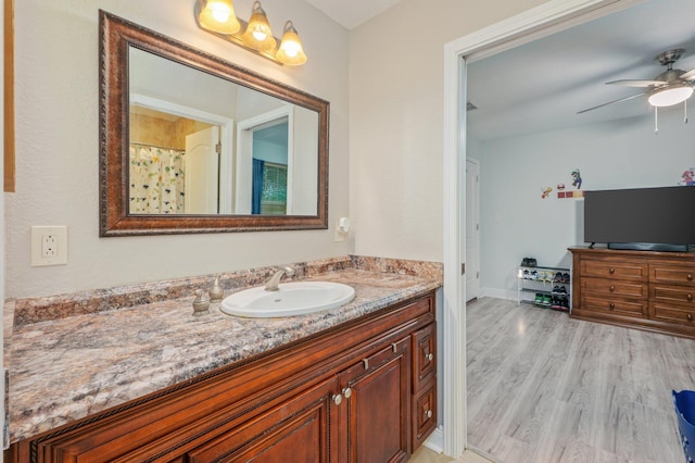 bathroom with vanity, hardwood / wood-style floors, and ceiling fan