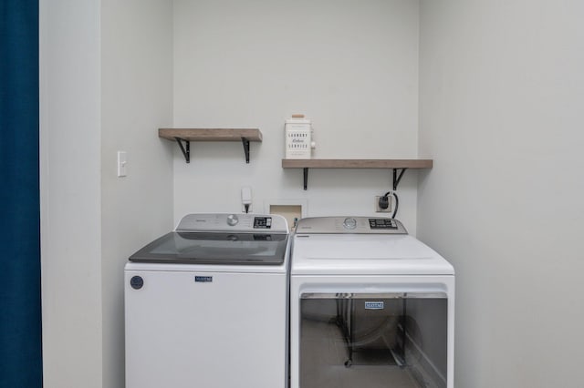 laundry room with washing machine and clothes dryer