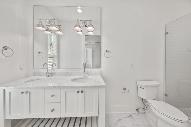 bathroom featuring vanity, a shower with shower door, and toilet