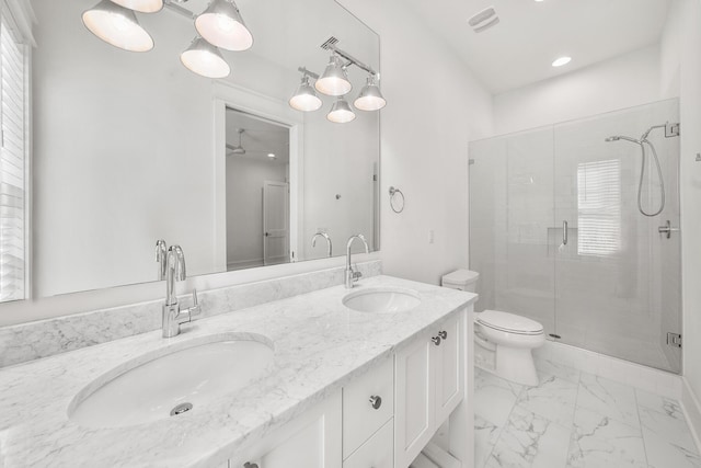 bathroom featuring plenty of natural light, ceiling fan, and a shower with shower door