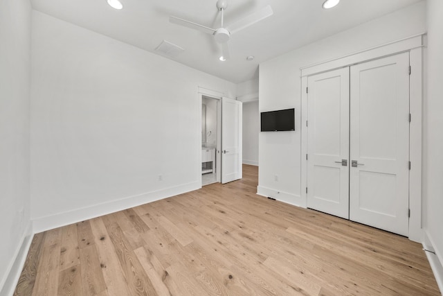 unfurnished bedroom featuring ceiling fan, light wood-type flooring, and a closet