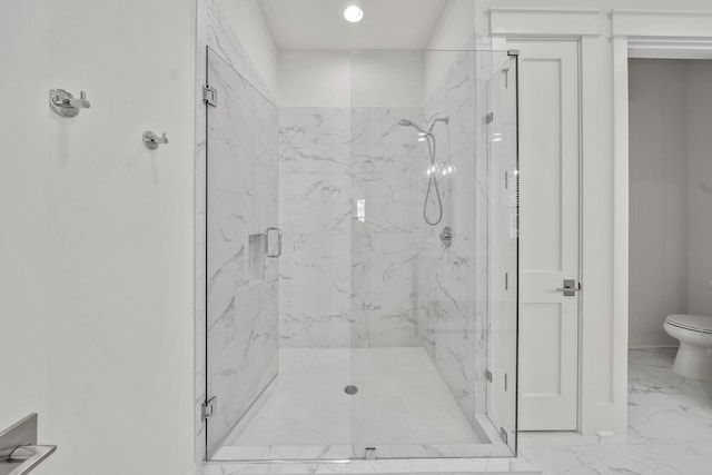 bathroom with a shower with shower door and toilet