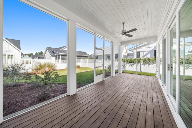 unfurnished sunroom with ceiling fan