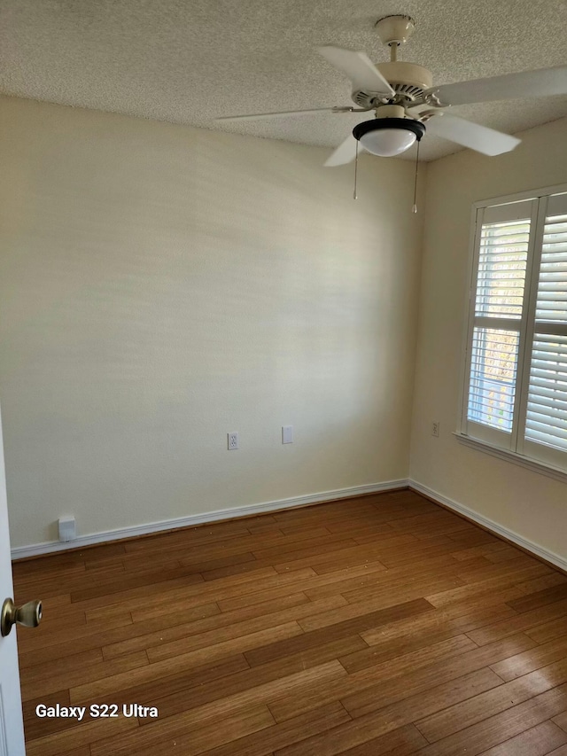 spare room featuring ceiling fan, hardwood / wood-style floors, and a textured ceiling