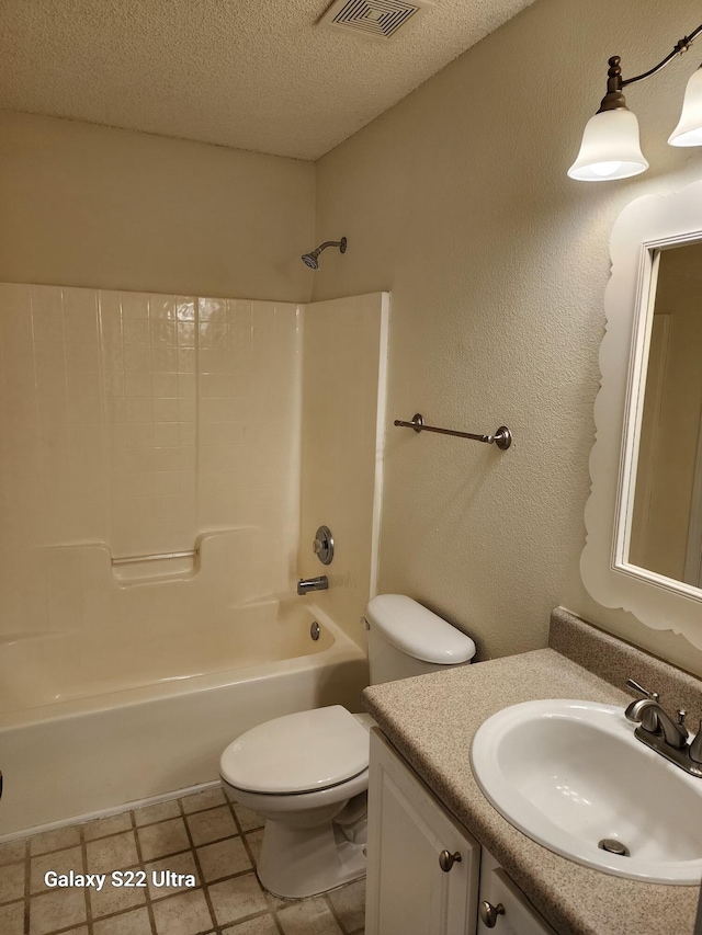 full bathroom with washtub / shower combination, tile patterned flooring, vanity, a textured ceiling, and toilet