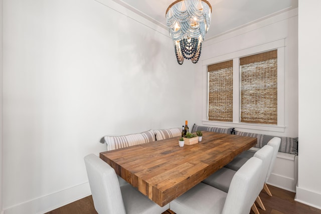 dining area with baseboards, a notable chandelier, and dark wood-style floors