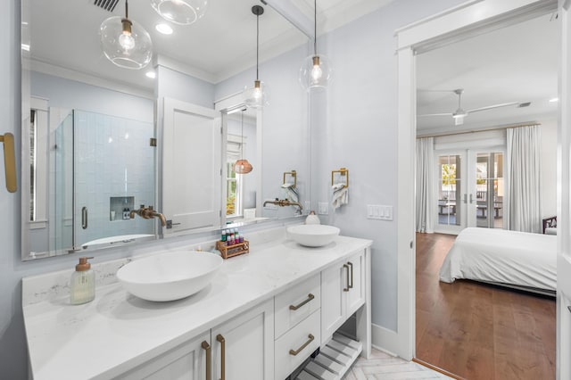 bathroom with french doors, a shower with shower door, wood-type flooring, ornamental molding, and vanity