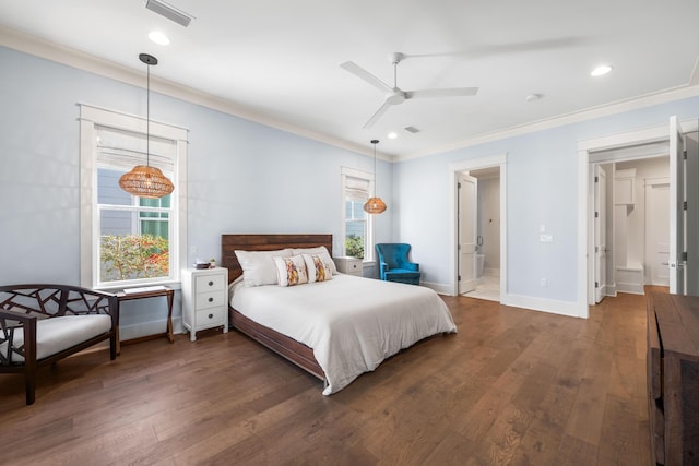 bedroom featuring crown molding, dark wood-type flooring, ensuite bathroom, and ceiling fan