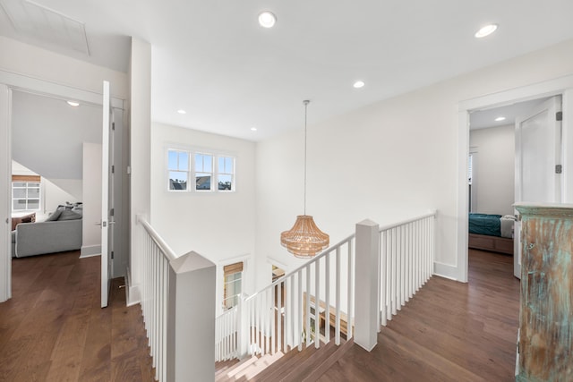 hall featuring an upstairs landing, recessed lighting, baseboards, and wood finished floors