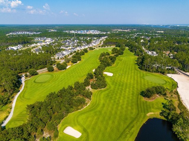 bird's eye view featuring golf course view and a water view