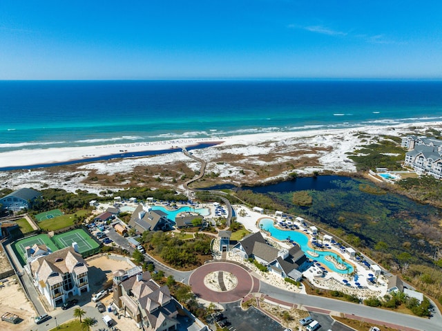 birds eye view of property featuring a beach view and a water view