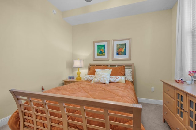 bedroom with baseboards and carpet