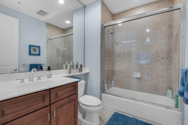bathroom with vanity, visible vents, tile patterned flooring, toilet, and combined bath / shower with glass door