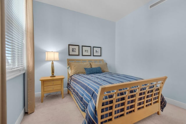 bedroom with carpet flooring, baseboards, and visible vents