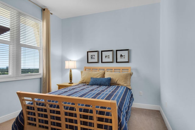 bedroom featuring carpet flooring and baseboards