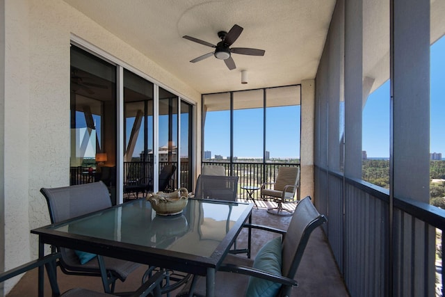 sunroom with a view of city and ceiling fan
