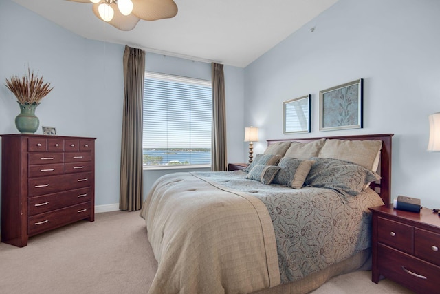 bedroom featuring light colored carpet, baseboards, and ceiling fan