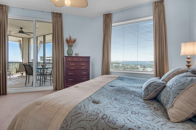 bedroom with access to exterior, multiple windows, a ceiling fan, and carpet