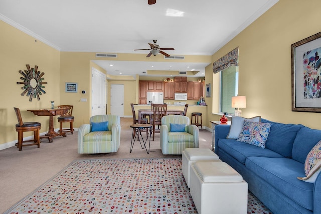 living room with a ceiling fan, baseboards, visible vents, ornamental molding, and light colored carpet