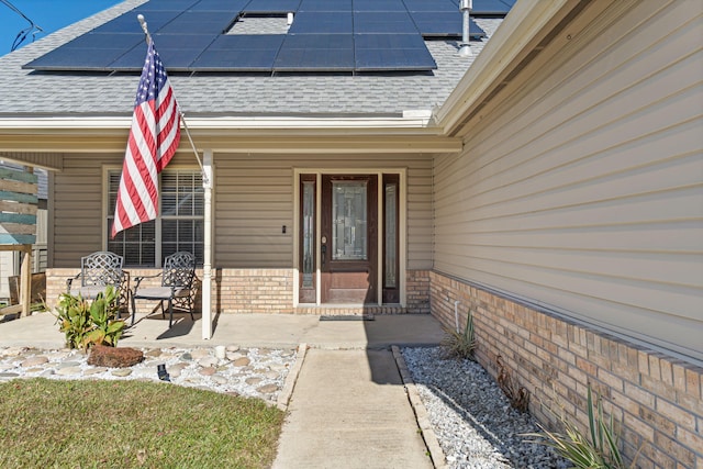 entrance to property featuring solar panels